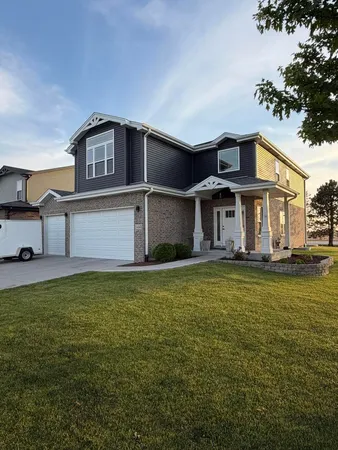 a front view of a house with a garden