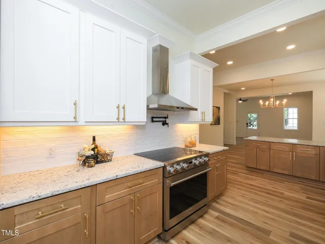 a kitchen with stainless steel appliances granite countertop a sink stove and cabinets
