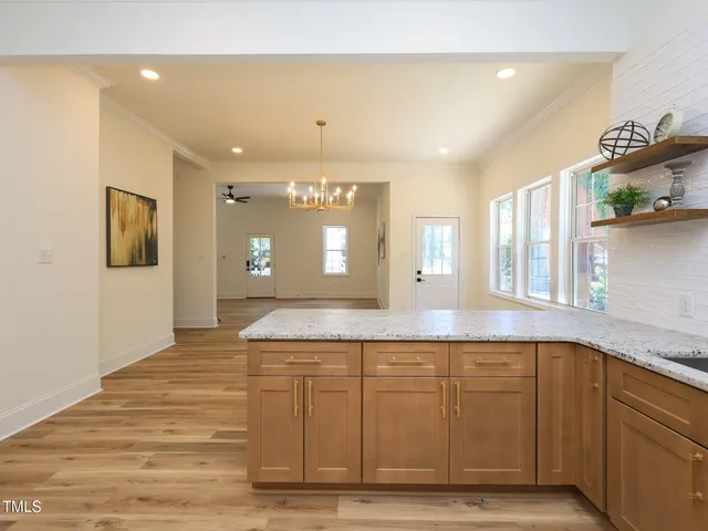 a spacious bathroom with a sink a mirror and shower