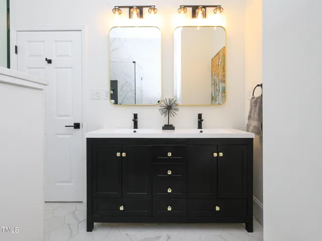 a bathroom with a double vanity sink and mirror