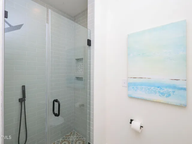 an empty room with a window and ceiling fan