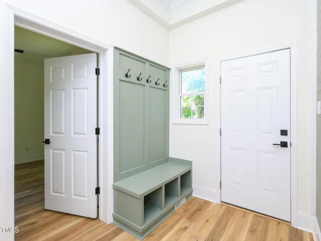 a view of a room with wooden floor