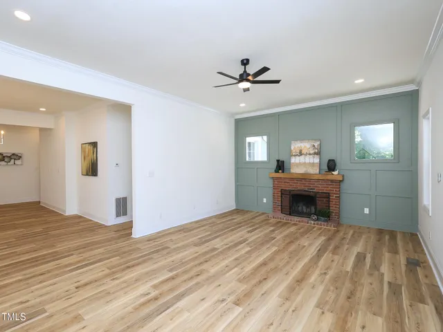 a view of empty room with wooden floor