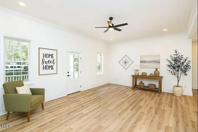 a living room with furniture and a wooden floor