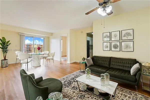 a living room with furniture a rug and a window