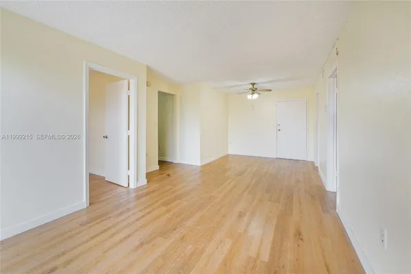 a view of a room with wooden floor