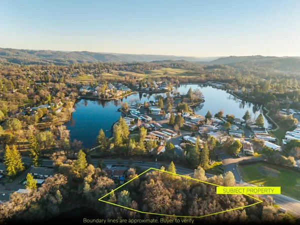 an aerial view of residential houses with outdoor space
