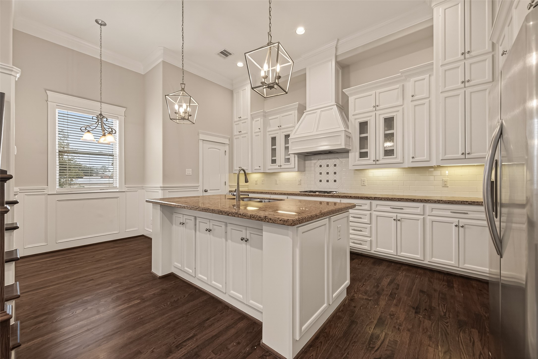 1431 West 25th Street Houston, TX 77008 - Photo 14 of 43 a kitchen with granite countertop white cabinets a sink a window and wooden floor
