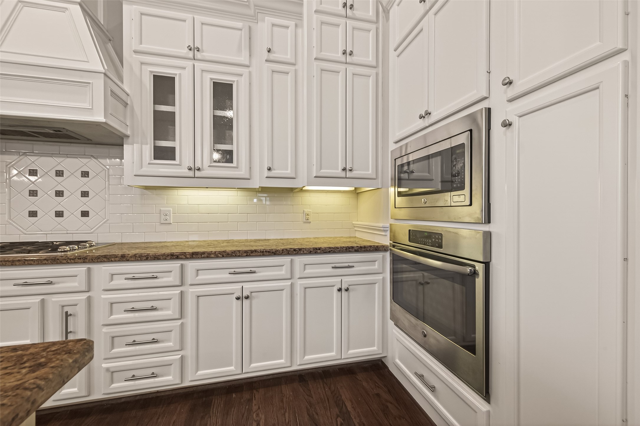 1431 West 25th Street Houston, TX 77008 - Photo 15 of 43 a kitchen with granite countertop white cabinets and stainless steel appliances