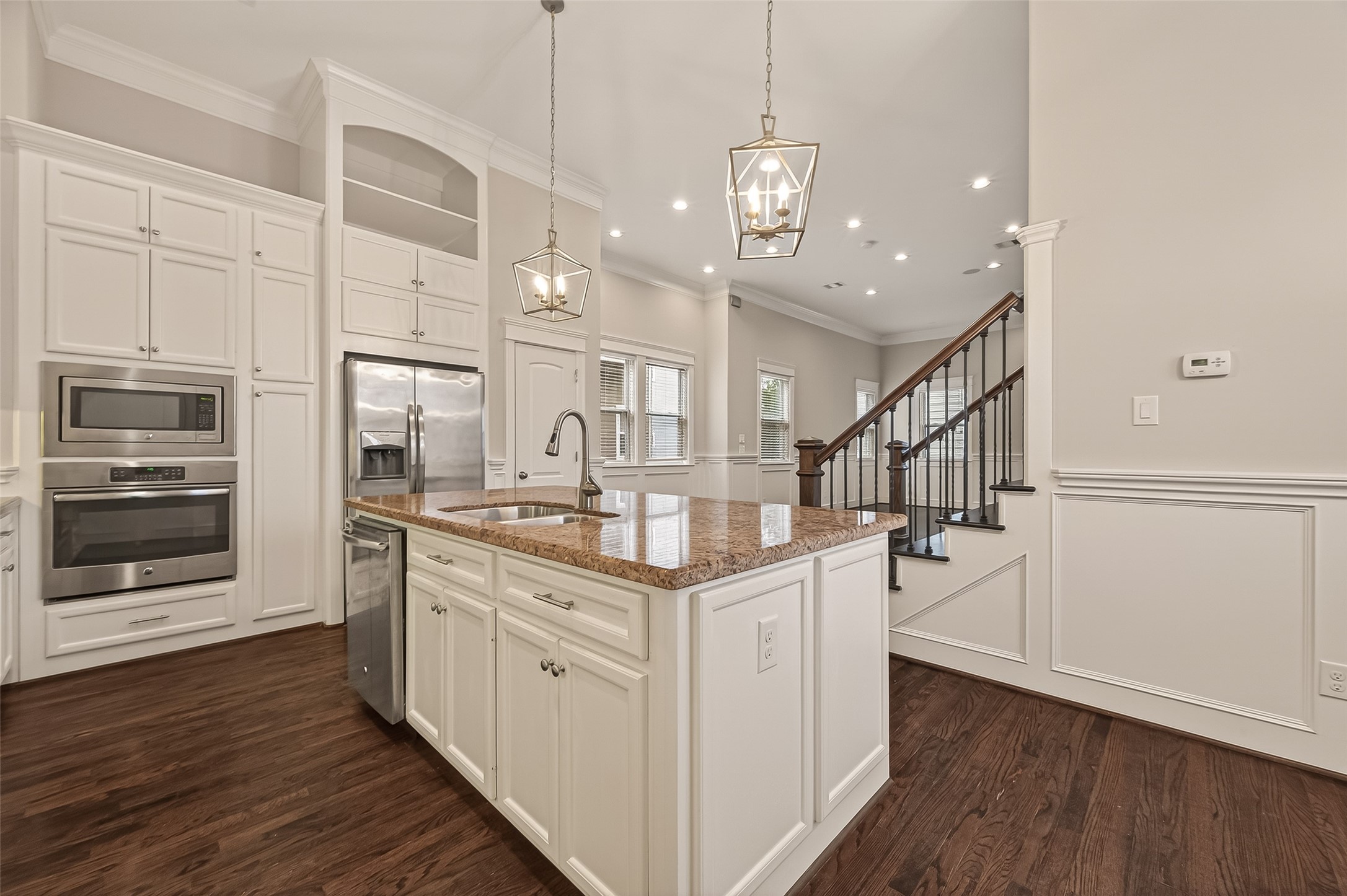 1431 West 25th Street Houston, TX 77008 - Photo 18 of 43 a kitchen with stainless steel appliances kitchen island granite countertop a stove top oven a sink and a refrigerator