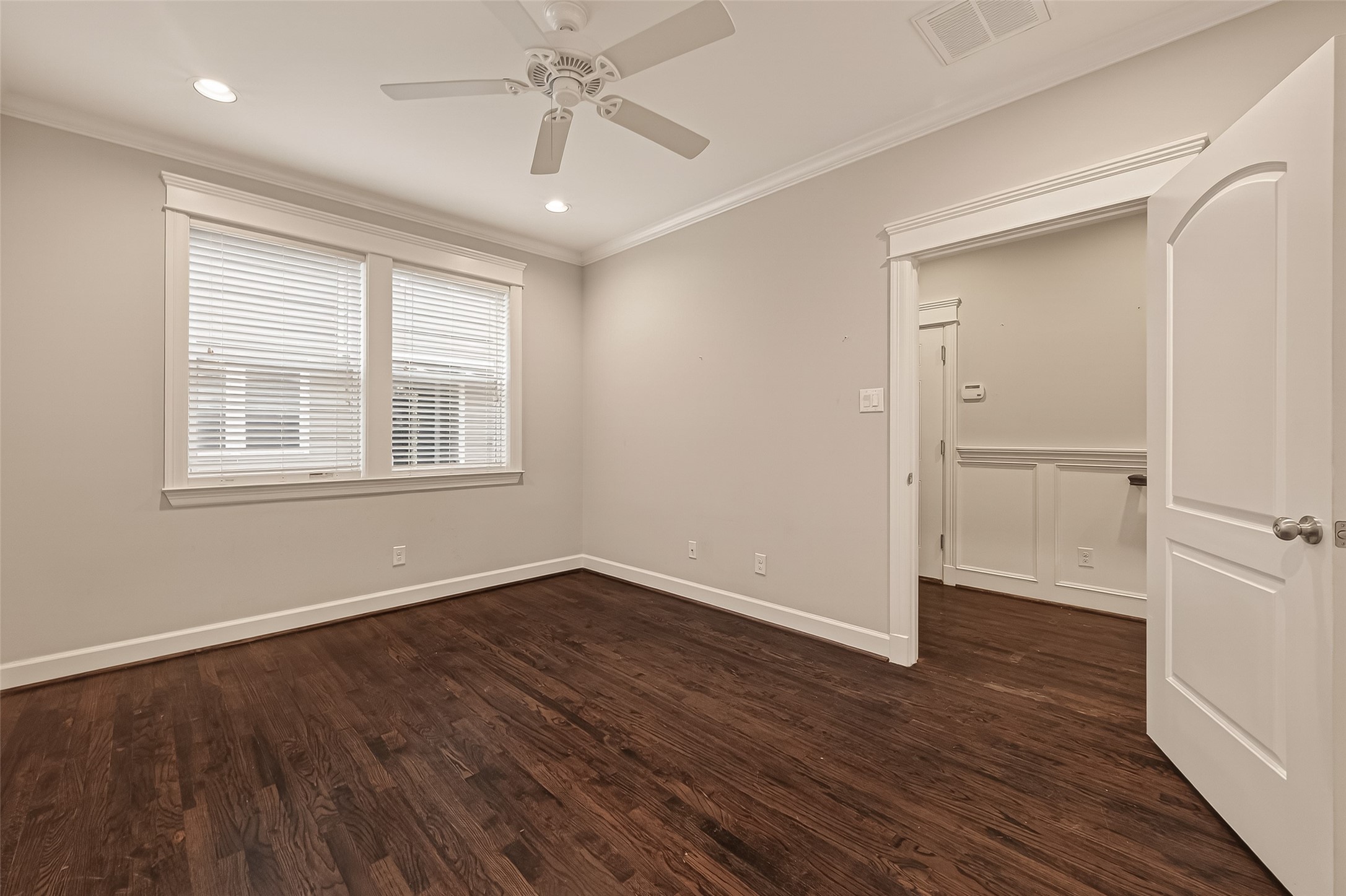 1431 West 25th Street Houston, TX 77008 - Photo 24 of 43 a view of an empty room with wooden floor and a window