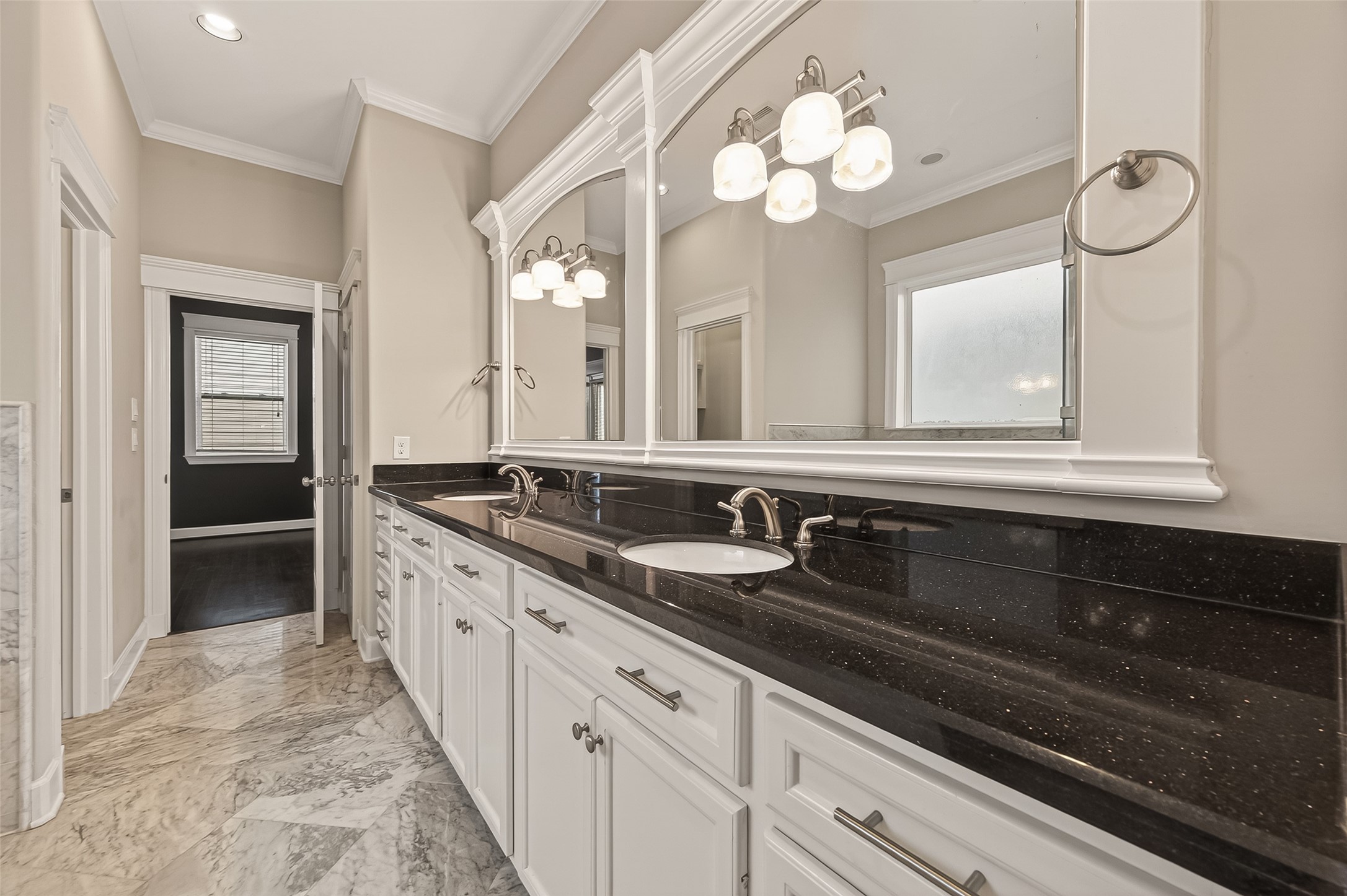 1431 West 25th Street Houston, TX 77008 - Photo 41 of 43 a bathroom with double vanity sinks a vanity a lamp and a mirror
