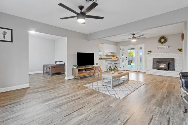 a living room with furniture a fireplace and a flat screen tv