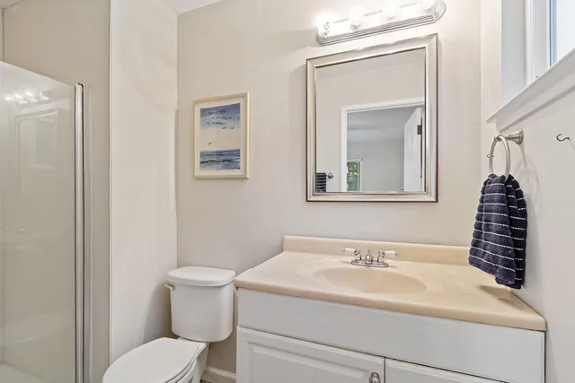a bathroom with a sink toilet and mirror