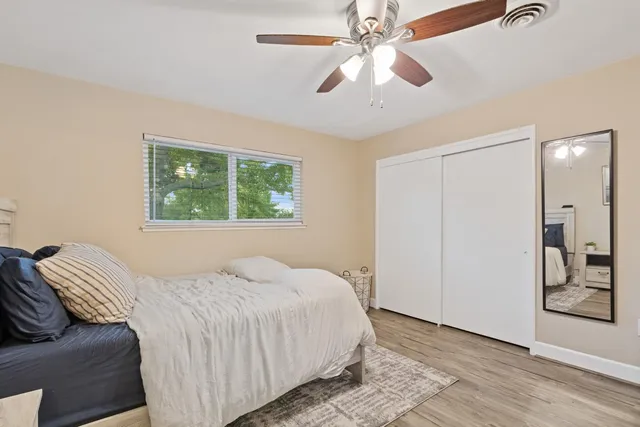 a bedroom with a large bed and a chandelier