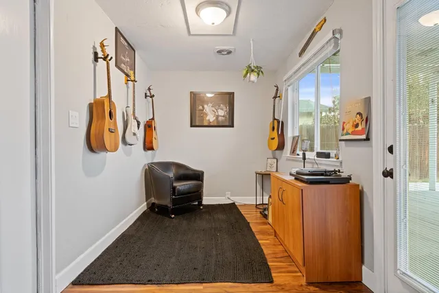 a hallway with a stove and a wooden floor