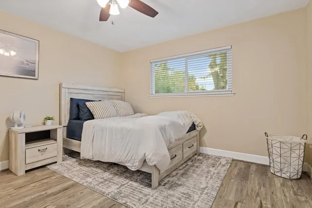 a bedroom with a bed and a ceiling fan