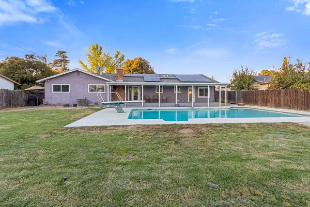 a front view of a house with a garden and yard