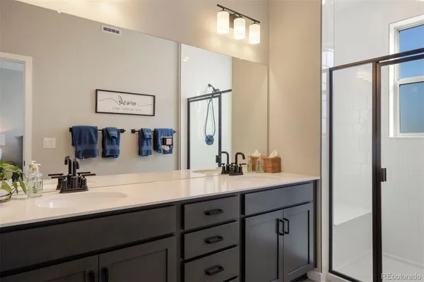 a bathroom with a double vanity sink and a mirror