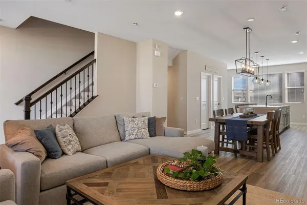 a living room with furniture and a chandelier