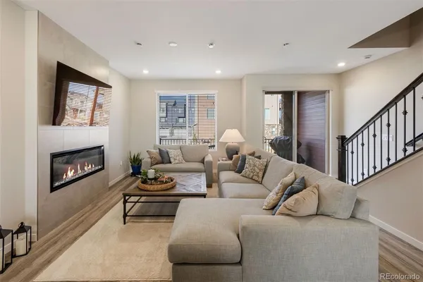 a living room with furniture and a fireplace
