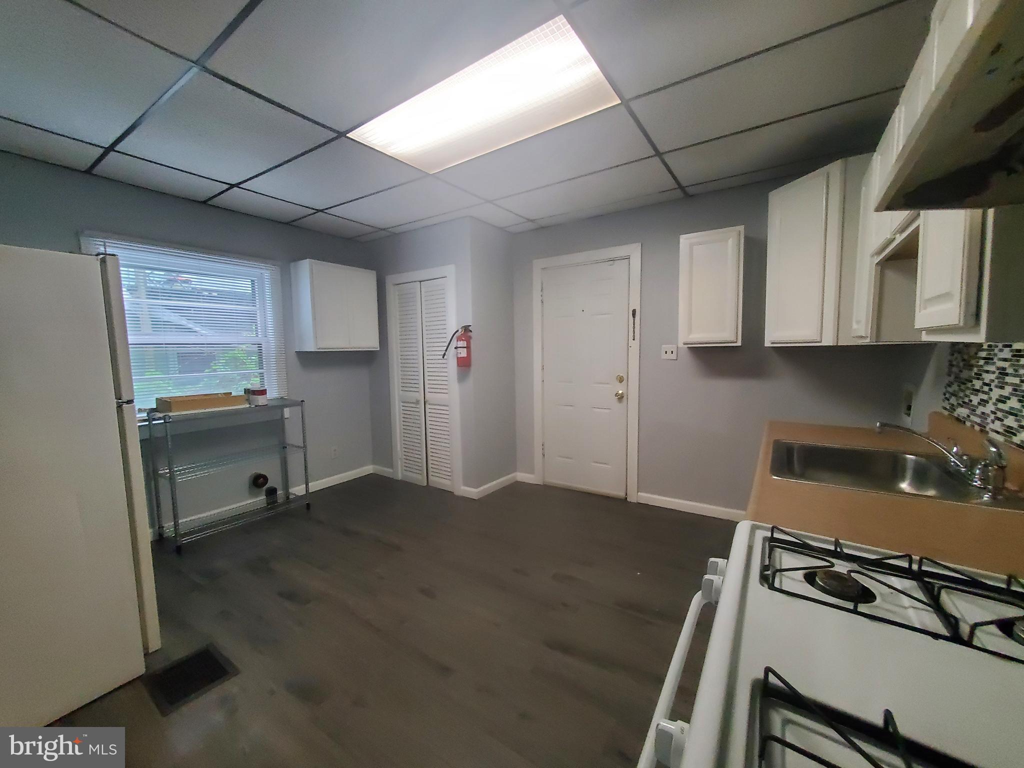 a kitchen with a stove a refrigerator and cabinets