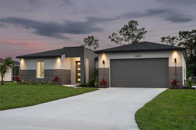 a front view of a house with a yard and garage
