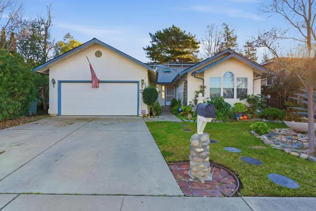 a front view of house with yard and green space