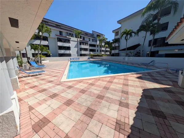 a view of a house with backyard sitting area and swimming pool