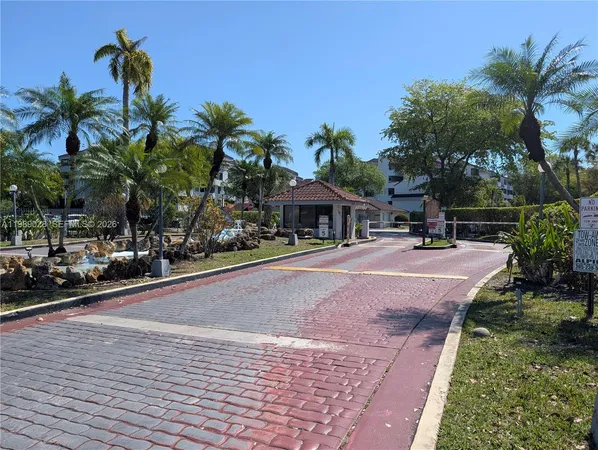 a palm tree sitting in front of a house with a patio