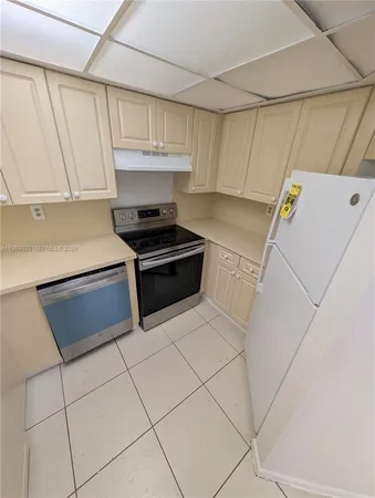a kitchen with a stove and a refrigerator