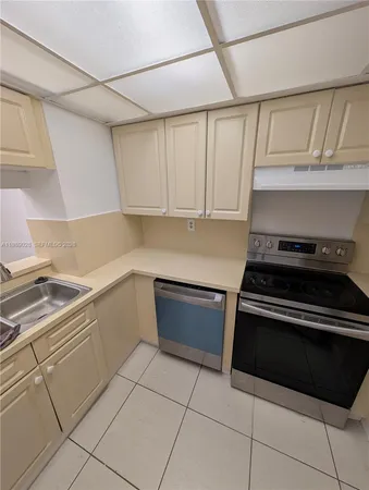 a kitchen with a stove and a sink