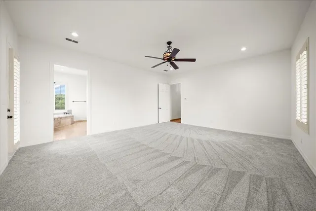 a view of a livingroom with a ceiling fan and window