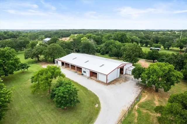 a view of a house with a backyard and garage