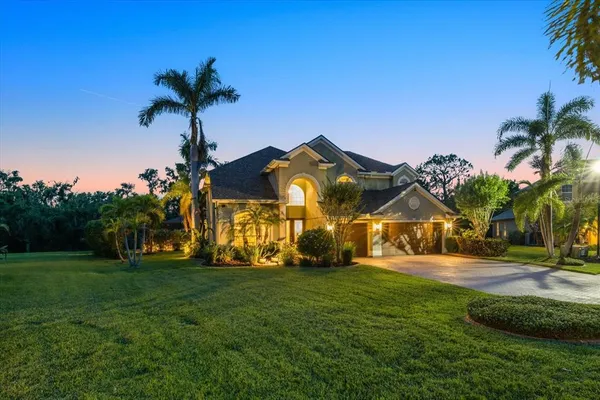 a front view of a house with a garden and yard