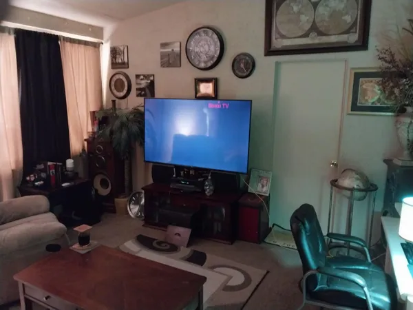 a view of living room with furniture and a fireplace