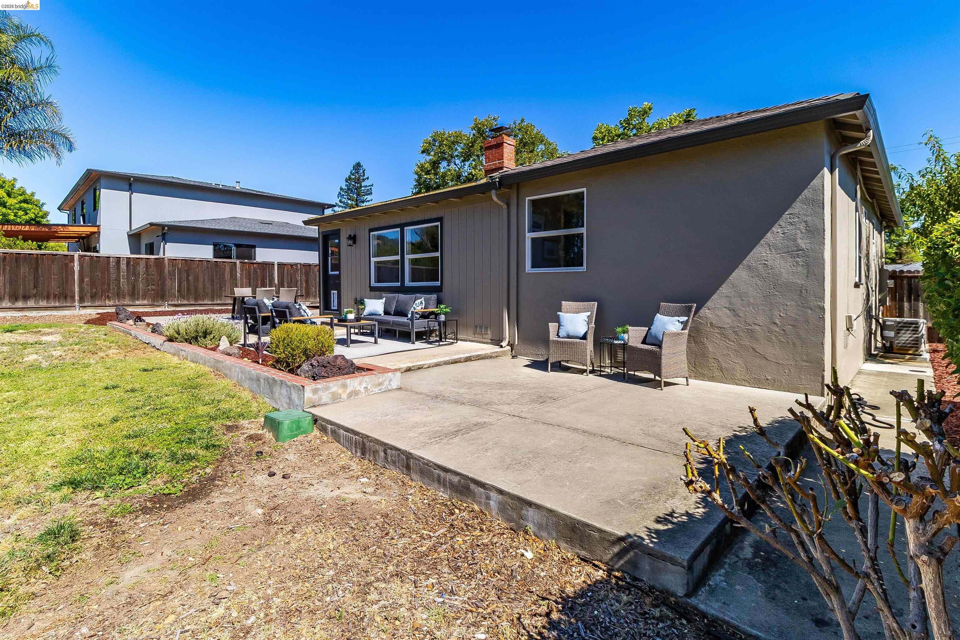 346 Valley View Road Pleasant Hill, CA 94523 - Photo 45 of 57 Expansive concrete patio area extending from the home, offering multiple zones for outdoor living