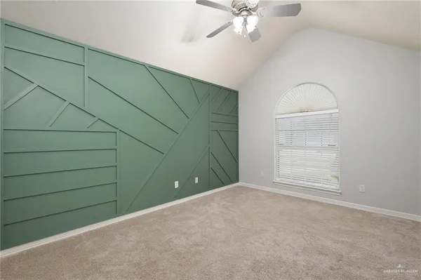 en empty room with windows and fan