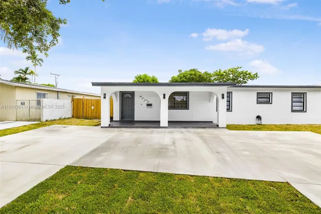 a view of a house with pool and a yard