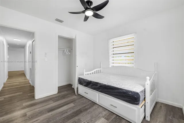 a bed room with a bed and a window