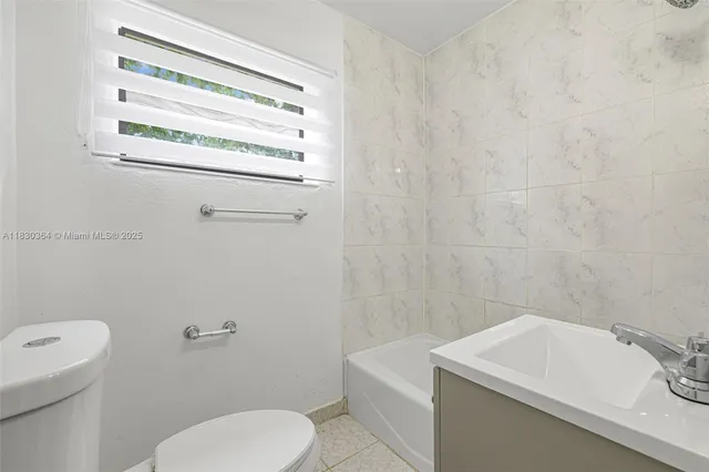 a bathroom with a sink a toilet and a bathtub