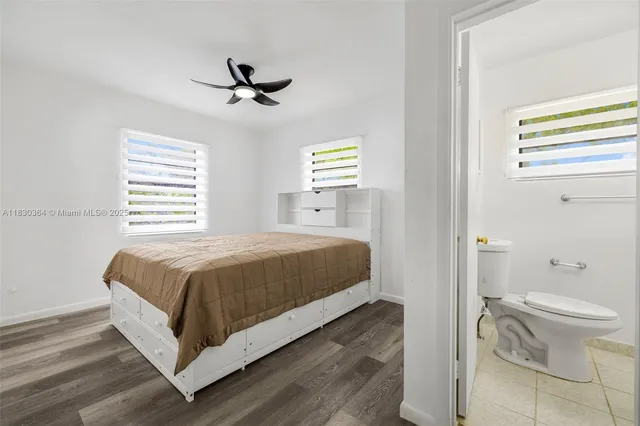 a spacious bedroom with a bed and a window