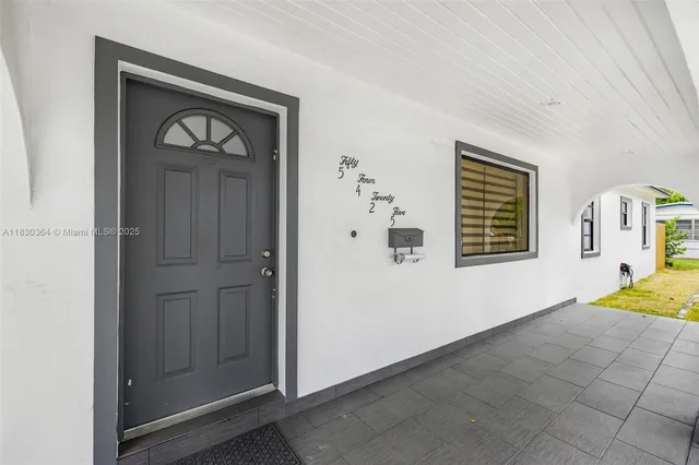 a view of a hallway to a bedroom with a window