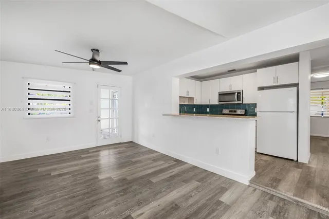 a view of a kitchen with electric appliances