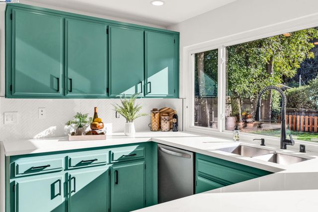 a kitchen with sink and large window
