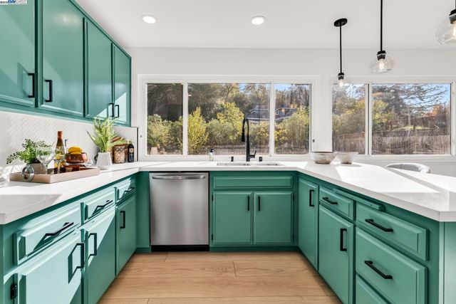 a kitchen with stainless steel appliances and refrigerator