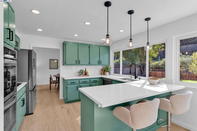 a view of a dining room with furniture a chandelier and wooden floor