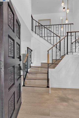 a view of staircase with lots of frames on wall and a view of entryway