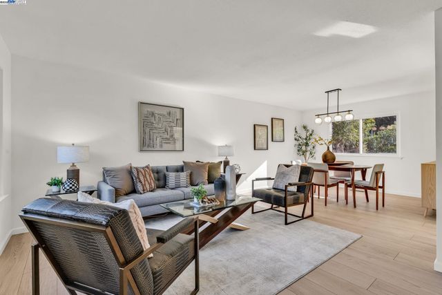 a view of a dining room with furniture and a large window