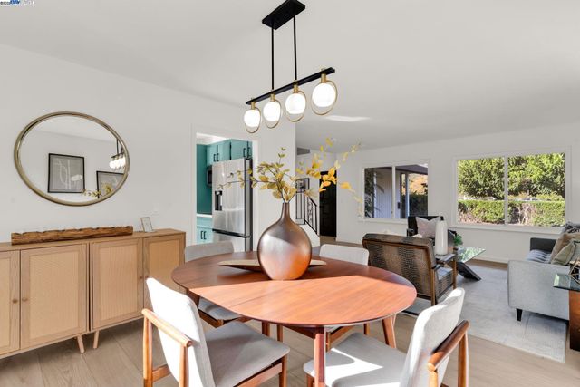 a view of a dining room with furniture and chandelier